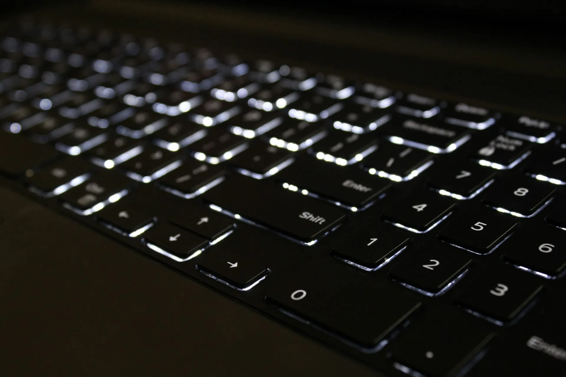 Backlit laptop keyboard in a dark room