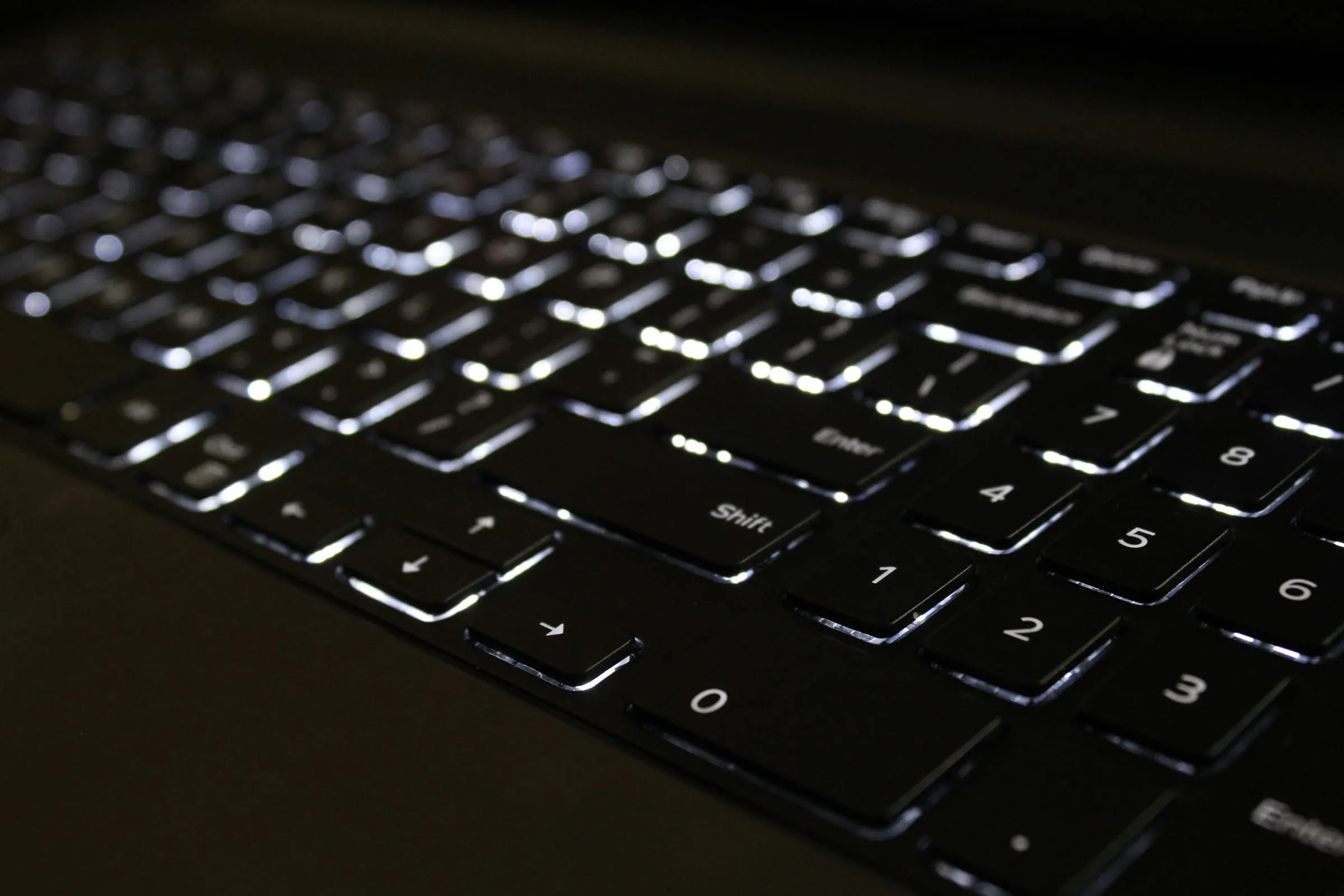 Backlit laptop keyboard in a dark room
