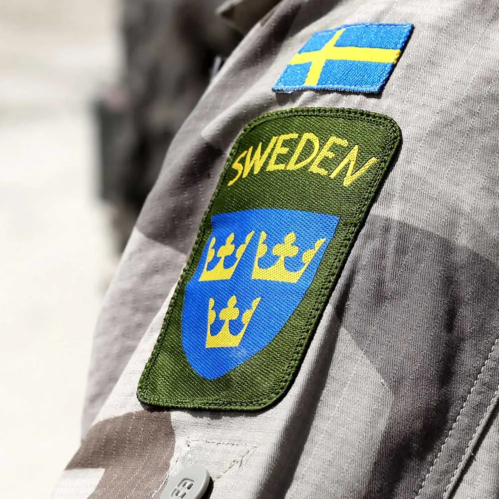 Sweden patch with the three crowns and the Swedish flag on a uniform sleeve